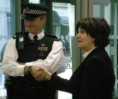 q_chrisitne_shaking_hand_inspector_police